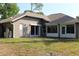 Exterior view of a home featuring a door, sliding glass door, and a screened-in porch at 4027 Quaker Ln, North Port, FL 34288
