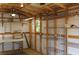 Spacious garage with metal shelving, pegboard and work table, perfect for workshop or storage at 4027 Quaker Ln, North Port, FL 34288