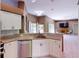 Open kitchen features white cabinetry, granite countertops, and stainless steel appliances at 4027 Quaker Ln, North Port, FL 34288