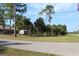 View of a property featuring a storage shed and tall trees, offering a serene, private setting at 4027 Quaker Ln, North Port, FL 34288