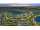 Expansive aerial view of a community featuring tennis courts, swimming pools, lush greenery, and well-maintained homes at 43030 Greenway Blvd # 426, Punta Gorda, FL 33982