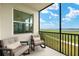 Enjoy outdoor living on the screened balcony with comfortable seating and views at 43030 Greenway Blvd # 426, Punta Gorda, FL 33982