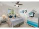 This bedroom includes a ceiling fan, neutral paint, and natural light at 43030 Greenway Blvd # 426, Punta Gorda, FL 33982