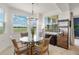 Inviting dining room with contemporary table and serene golf course and lake views through large windows at 43030 Greenway Blvd # 426, Punta Gorda, FL 33982