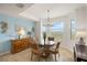 Cozy dining room bathed in natural light with elegant table and chairs, and serene lake views at 43030 Greenway Blvd # 426, Punta Gorda, FL 33982