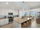 Open concept kitchen with granite countertops, stainless appliances, and adjacent dining area overlooking a lake at 43030 Greenway Blvd # 426, Punta Gorda, FL 33982