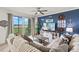 Stylish living room with comfortable sofa, TV, and sliding door access to a screened patio at 43030 Greenway Blvd # 426, Punta Gorda, FL 33982