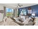 Stylish living room with comfortable sofa, TV, and sliding door access to a screened patio at 43030 Greenway Blvd # 426, Punta Gorda, FL 33982