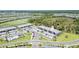 Desirable aerial view of a new community with condos, a golf course and lush greenery at 43984 Boardwalk Loop # 1726, Punta Gorda, FL 33982