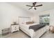 Bright bedroom featuring a queen bed, ceiling fan, and neutral decor at 43984 Boardwalk Loop # 1726, Punta Gorda, FL 33982