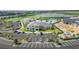 Aerial view of the clubhouse and ample parking surrounded by palm trees at 43984 Boardwalk Loop # 1726, Punta Gorda, FL 33982