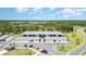Low angle shot of modern condos with garages and well manicured landscaping at 43984 Boardwalk Loop # 1726, Punta Gorda, FL 33982