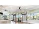 Bright gym featuring pull-up bars, mirror, and large windows with views of trees at 43984 Boardwalk Loop # 1726, Punta Gorda, FL 33982