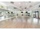Spacious gym featuring large mirrors, various exercise equipment and views of palm trees at 43984 Boardwalk Loop # 1726, Punta Gorda, FL 33982