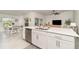 Bright kitchen with a large island, stainless steel appliances, and an open concept layout flowing to the living room at 43984 Boardwalk Loop # 1726, Punta Gorda, FL 33982