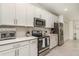 A modern kitchen featuring stainless steel appliances, white cabinets, and plenty of counter space at 43984 Boardwalk Loop # 1726, Punta Gorda, FL 33982