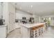 Modern kitchen with stainless steel appliances, white cabinets, and breakfast bar seating at 43984 Boardwalk Loop # 1726, Punta Gorda, FL 33982