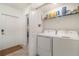 Convenient laundry room with washer, dryer, and storage shelves at 43984 Boardwalk Loop # 1726, Punta Gorda, FL 33982