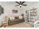 Comfortable room with fan, sofa, and bookshelf for relaxing or entertaining at 43984 Boardwalk Loop # 1726, Punta Gorda, FL 33982