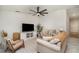 Bright living room with comfortable seating, neutral tones, and modern ceiling fan at 43984 Boardwalk Loop # 1726, Punta Gorda, FL 33982
