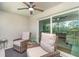 Cozy covered patio with wicker chairs, ceiling fan, and sliding glass doors to bring the outdoors in at 43984 Boardwalk Loop # 1726, Punta Gorda, FL 33982