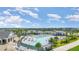 Scenic view of the community pool surrounded by mature palm trees and green spaces at 43984 Boardwalk Loop # 1726, Punta Gorda, FL 33982