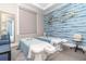 Relaxing spa with two massage beds, blue accent wall, gold decorations and soft lighting at 43984 Boardwalk Loop # 1726, Punta Gorda, FL 33982