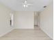Well-lit bedroom featuring light-colored floors, a ceiling fan, and a view into the next room at 5331 Citadel Rd, Venice, FL 34293
