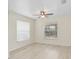 Bright bedroom featuring light-colored floors, two windows, and neutral-colored walls at 5331 Citadel Rd, Venice, FL 34293