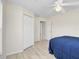 Bedroom features light-colored floors, a ceiling fan, and access to a closet and hallway at 5331 Citadel Rd, Venice, FL 34293
