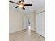 Bedroom featuring light-colored floors, a ceiling fan, and double closets and a doorway at 5331 Citadel Rd, Venice, FL 34293