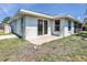 Rear exterior of home showing patio area, lush lawn, and mature landscaping at 5331 Citadel Rd, Venice, FL 34293