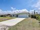 Single-story home with a long driveway and a two-car garage at 5331 Citadel Rd, Venice, FL 34293