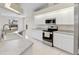 Modern kitchen featuring stainless steel appliances, a sink, and white cabinets at 5331 Citadel Rd, Venice, FL 34293