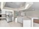 Modern kitchen with stainless steel appliances, white cabinets, breakfast bar, and tile flooring at 5331 Citadel Rd, Venice, FL 34293