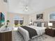 Staged main bedroom with a ceiling fan, picture on the wall, and furniture at 5331 Citadel Rd, Venice, FL 34293