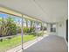 Screened in patio with brick flooring offering views of the beautifully landscaped backyard at 5331 Citadel Rd, Venice, FL 34293