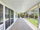 Covered patio with brick flooring, screen enclosure, and views of the landscaped backyard at 5331 Citadel Rd, Venice, FL 34293