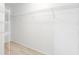 Walk-in closet featuring white wire shelves and modern light-colored wood floors at 5331 Citadel Rd, Venice, FL 34293