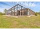 View of the back of the home which includes the outdoor enclosed pool at 8183 Deland St, Port Charlotte, FL 33981