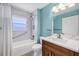 Updated bathroom featuring a tub with shower, wooden vanity and granite countertop at 8183 Deland St, Port Charlotte, FL 33981