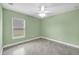 Simple bedroom with green walls, a ceiling fan, and ceramic tile flooring at 8183 Deland St, Port Charlotte, FL 33981
