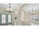 Bright foyer with arched entryways and decorative lighting, creating an elegant and welcoming entrance at 8183 Deland St, Port Charlotte, FL 33981