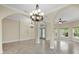 Open-concept foyer with arched details, stylish chandeliers and tile flooring, offering a sophisticated ambiance at 8183 Deland St, Port Charlotte, FL 33981