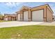 View of the spacious three-car garage with automatic white doors and concrete driveway at 8183 Deland St, Port Charlotte, FL 33981
