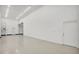 Well-lit three-car garage showcases polished concrete floors and access doors at 8183 Deland St, Port Charlotte, FL 33981