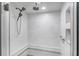 Modern shower featuring multiple shower heads, marble-tiled walls and a corner bench at 8183 Deland St, Port Charlotte, FL 33981
