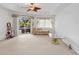 Bedroom with a ceiling fan, chaise lounge, and access to a pool through sliding glass doors at 8377 Mambo Ave, North Port, FL 34291