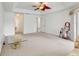 Spacious bedroom featuring a ceiling fan, glass table, and doorway access to other rooms at 8377 Mambo Ave, North Port, FL 34291