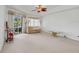 Bright bedroom with a ceiling fan, a chaise lounge, and sliding glass doors to the outdoor pool at 8377 Mambo Ave, North Port, FL 34291
